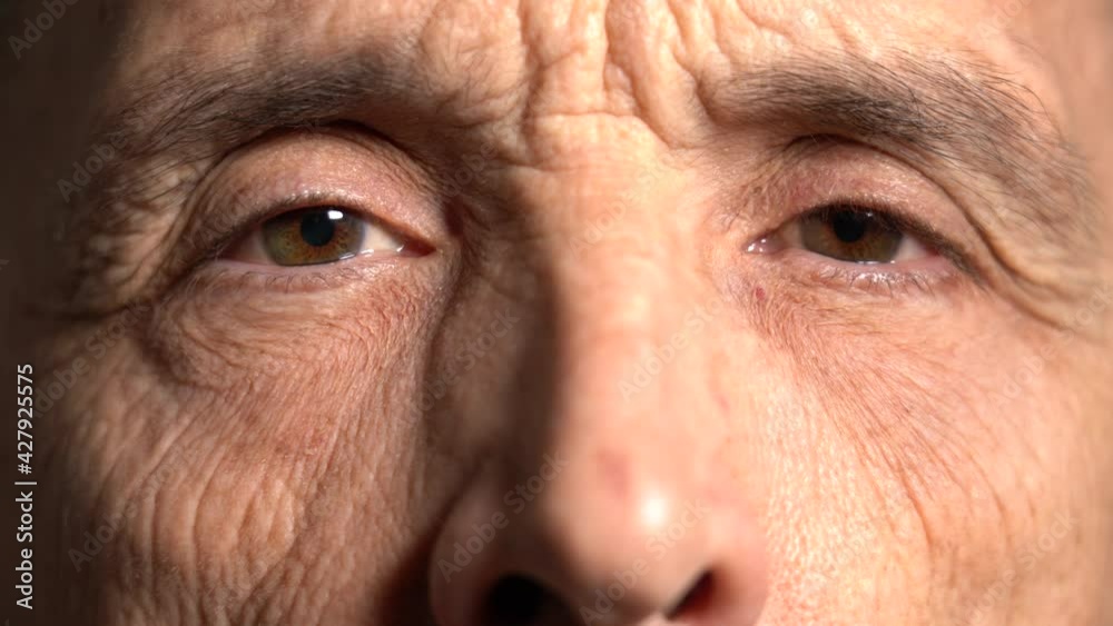 Close-up. the elderly man stared at the camera. reflection of light in the eyes. old age concept. Close-up. the elderly man stared at the camera. reflection of light in the eyes. old age concept.