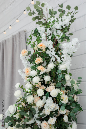 close-up of artificial flowers of white and pink color in the room.