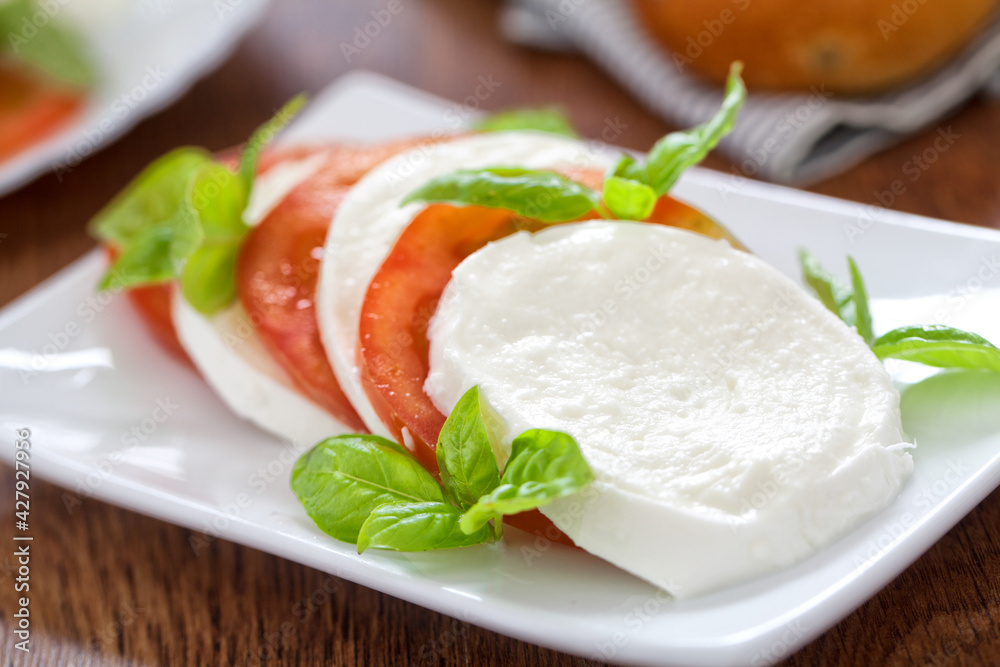 Caprese salad with mozzarella, tomatoes and fresh basil.