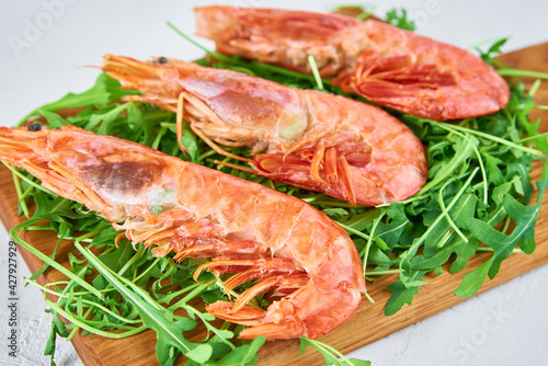 Red raw prawns, close up. Fresh shrimps with rucola. Seafood background