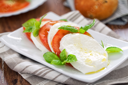 Caprese salad with mozzarella, tomatoes and fresh basil.