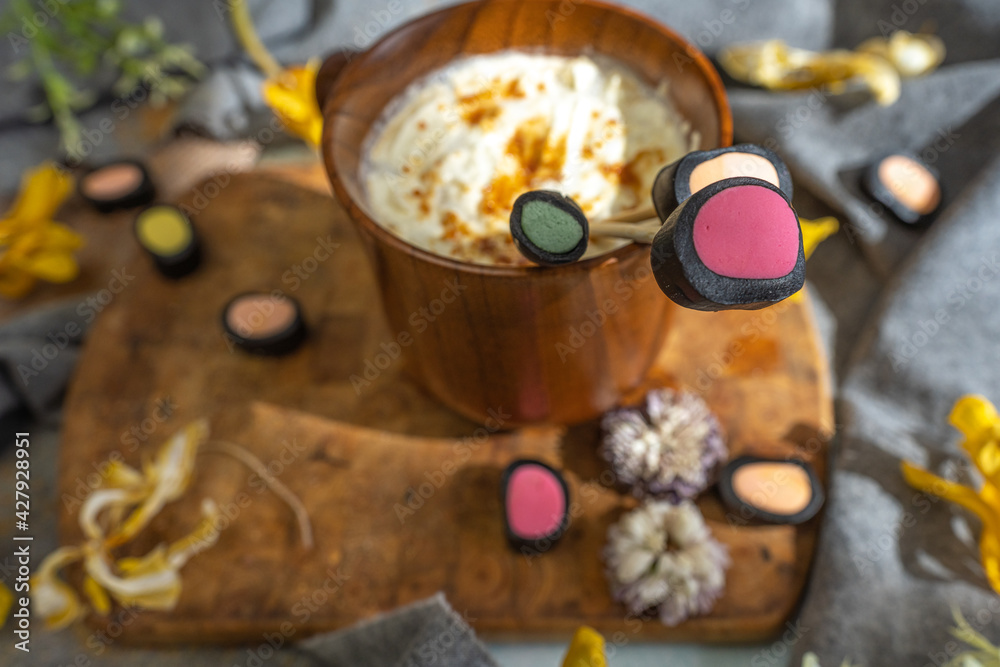 wooden coffee cup, dry yellow flowers, licorice candy,.  top view, layout,