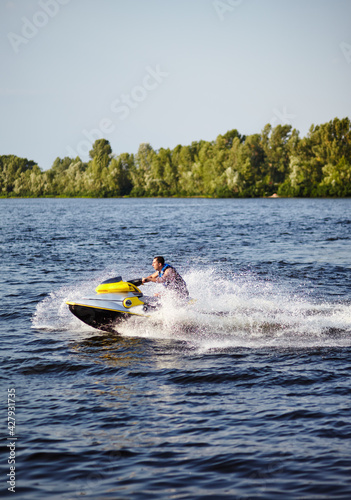 Man speeding on jet ski on lake during summer vacation © supersomik