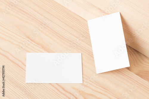 Blank business card template 85x55mm on natural wood texture background.	
