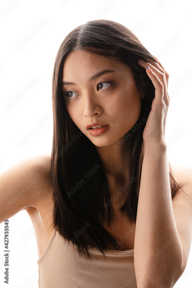 Young asian brunette woman posing and looking aside Young asian brunette woman posing and looking aside