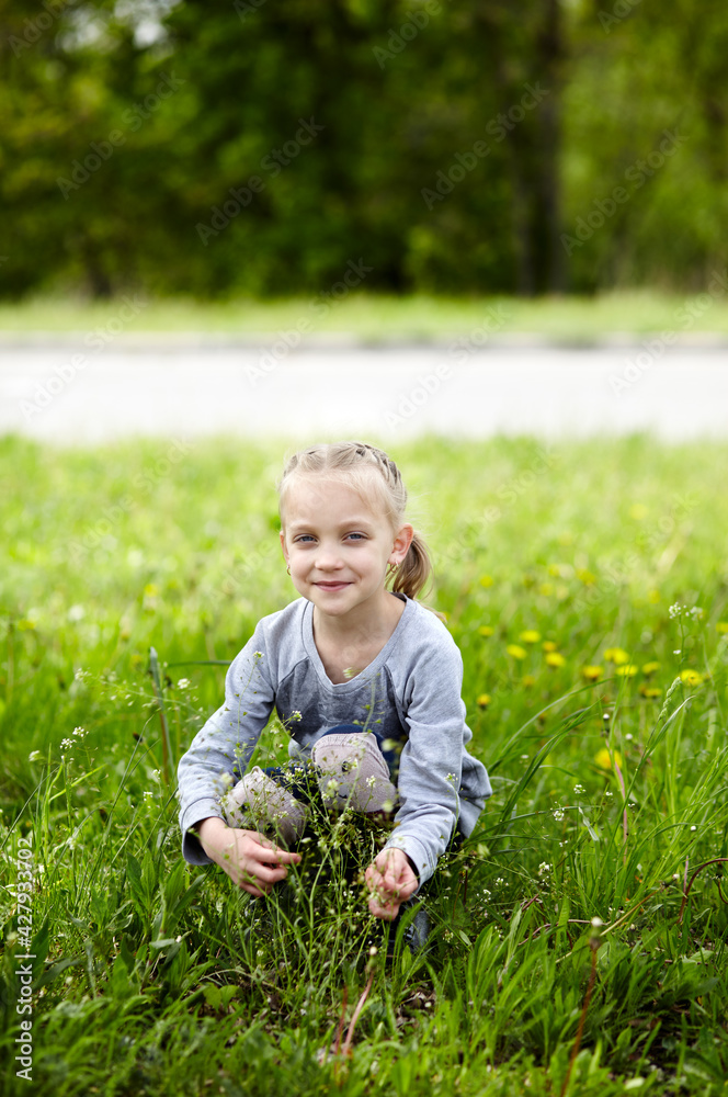 Little girl play in the park. The concept of a happy childhood, summer outdoor recreation, summer vacation Little girl play in the park. The concept of a happy childhood, summer outdoor recreation, summer vacation