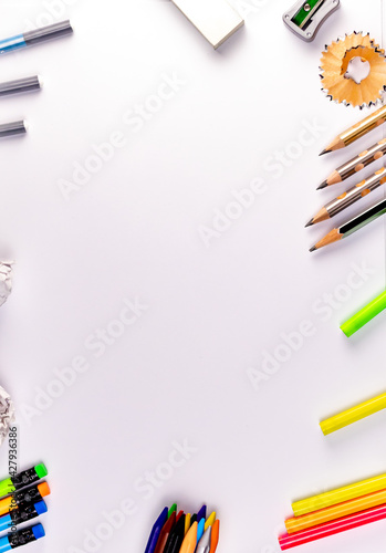 Top close up shot of pencils, crayons, sharpener and eraser on white background in art & craft concept.