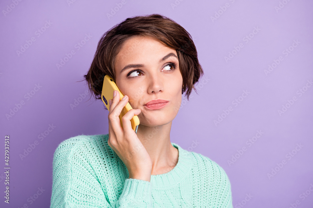 Portrait of attractive suspicious doubtful brown-haired girl calling using celllular isolated over violet purple color background Portrait of attractive suspicious doubtful brown-haired girl calling using celllular isolated over violet purple color background