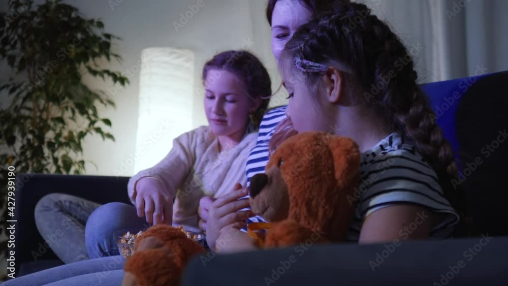 stay home. family - quarantine mom, daughter and small child are watching tv. coronavirus happy family together concept. happy family watching tv together. kid dream. people watching online movies stay home. family - quarantine mom, daughter and small child are watching tv. coronavirus happy family together concept. happy family watching tv together. kid dream. people watching online movies