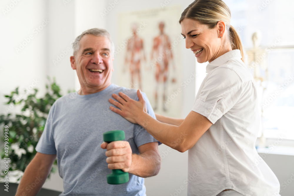 A Modern rehabilitation physiotherapy worker with senior client A Modern rehabilitation physiotherapy worker with senior client