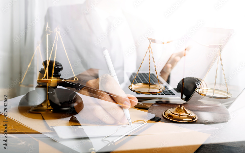 justice and law concept.Male judge in a courtroom on wooden table and Counselor or Male lawyer working in office. Legal law, advice and justice concept. justice and law concept.Male judge in a courtroom on wooden table and Counselor or Male lawyer working in office. Legal law, advice and justice concept.