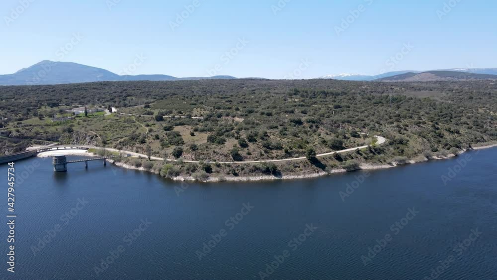 Panoramic aerial view of a swamp with road and cars driving along the shore. Panoramic aerial view of a swamp with road and cars driving along the shore.
