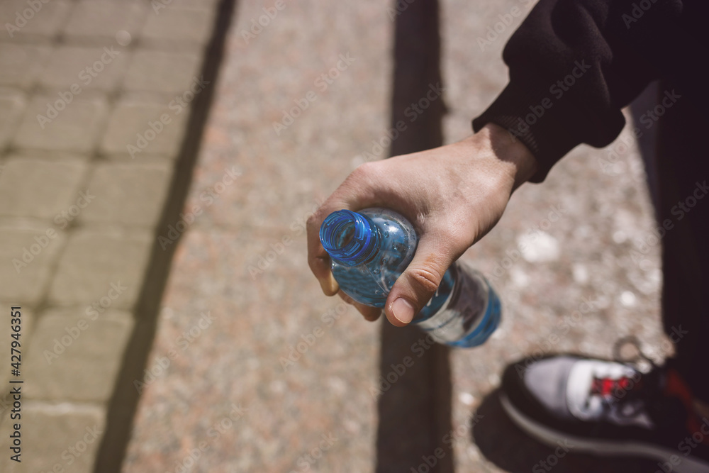 hand holding a bottle of water hand holding a bottle of water