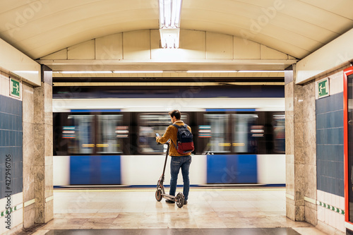 Guy Walking With Electric Scooter In Underground Passage