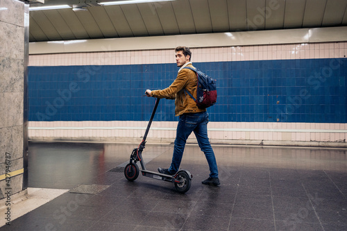 Guy Walking With Electric Scooter In Underground Passage