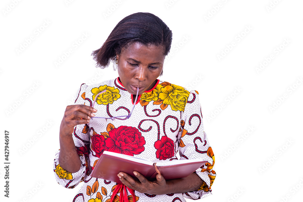adult business woman reading notes in notebook with glasses near mouth. adult business woman reading notes in notebook with glasses near mouth.