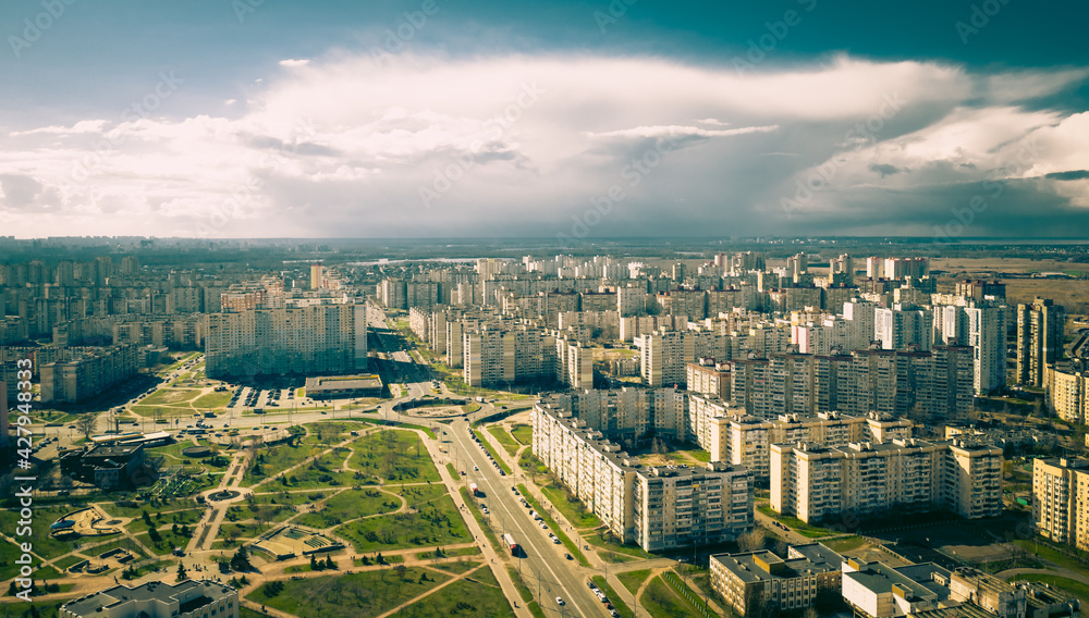 urban dormitory area in eastern europe. roundabout in the city. calm ordinary life and storm clouds approaching in the background. the cyclone is approaching the city . 4k 