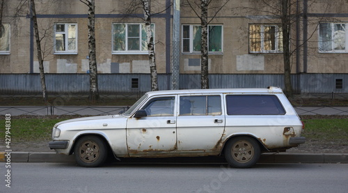 Old rusty Soviet car on the street, Iskrovsky Prospekt, Saint Petersburg, Russia, April 2021
