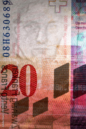 Macro detail of security features in reverse side of a twenty Swiss franc banknote featuring a watermark portrait of composer Arthur Honegger