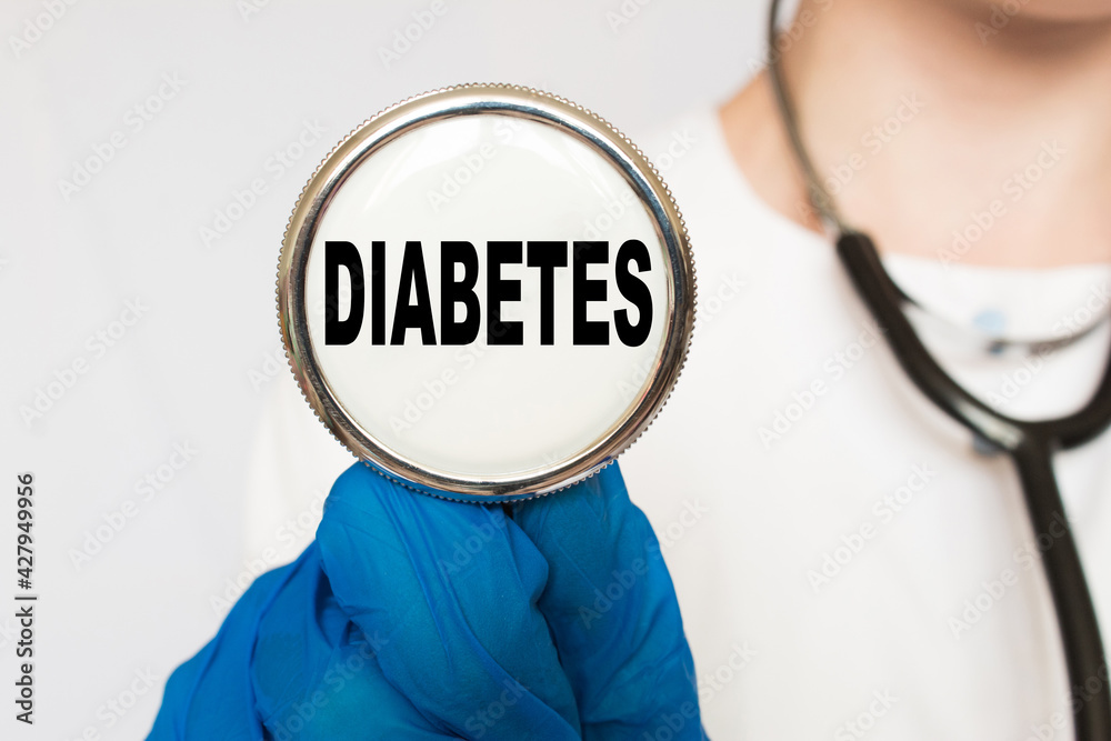 The doctor's blue - gloved hands show the word DIABETES - . a gloved hand on a white background. Medical concept. the medicine The doctor's blue - gloved hands show the word DIABETES - . a gloved hand on a white background. Medical concept. the medicine