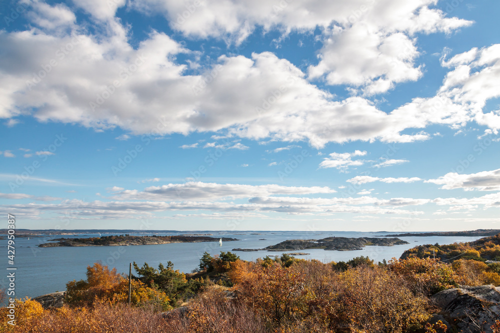 High-level view of the sea around islands of the Southern Gothenburg Archipelago, in Sweden, during a sunny day with blue sky and clouds. Archipelago of Gothenburg (Swedish: Göteborgs skärgård)