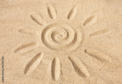 Sun sign on sand under sunlight