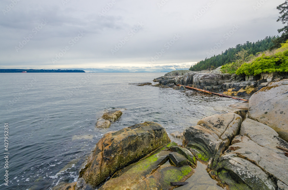 Fragment of a rocky beach with gorgeous view at Ocean, British Columbia, Canada.