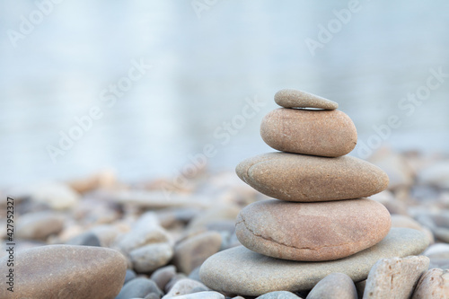 Balance stones close up on a stone beach at sunrise