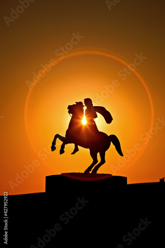 Silhouette of the statue of Alexander the Great (ancient king of Macedonia) riding his horse, Bucephalus. Located at the area of Nea Paralia, Thessaloniki, Macedonia, Greece. photo