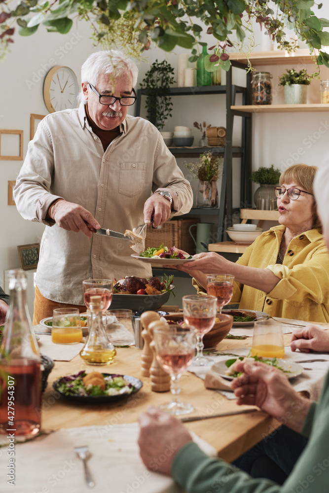 Senior people sitting at dining table and eating food during meeting at home Senior people sitting at dining table and eating food during meeting at home