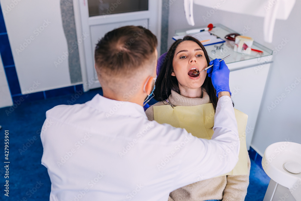 Obraz premium woman is being examined by dentist at dental clinic. The dentist