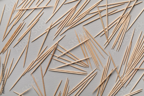 Fototapeta Naklejka Na Ścianę i Meble -  Wooden toothpicks on grey background, flat lay
