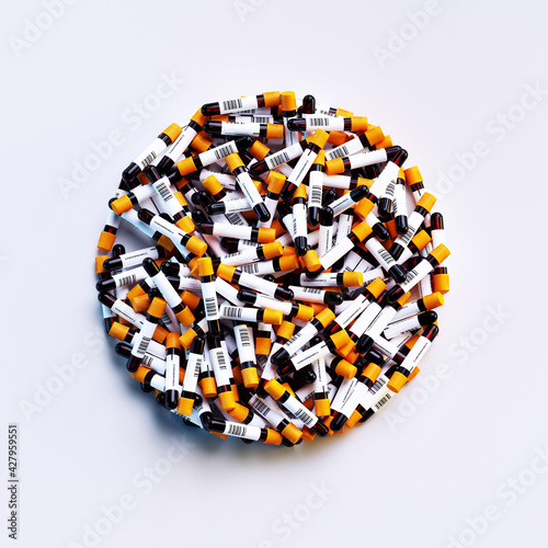 Bulk of Coronavirus blood sample test tubes with positive and negative indication on sticker