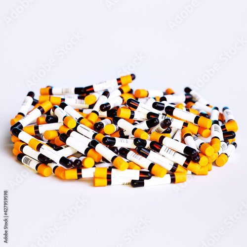 Bulk of Coronavirus blood sample test tubes with positive and negative indication on sticker