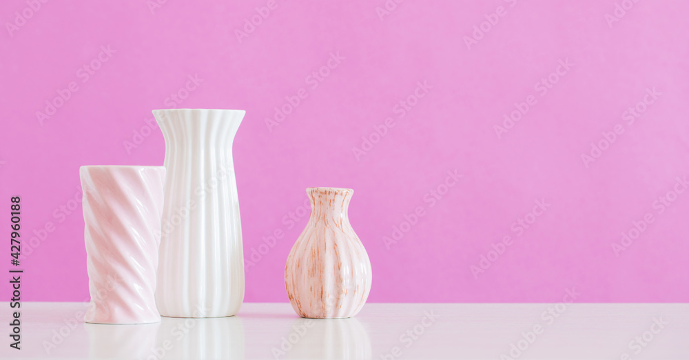 white and pink vases  on pink background