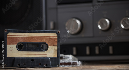 old tape recorder and cassette on  wooden table photo