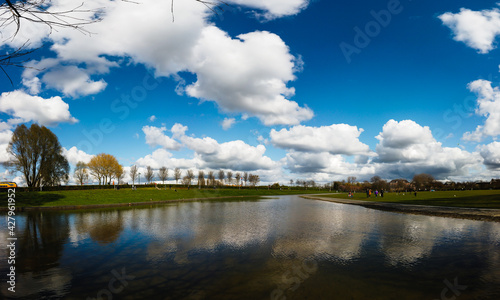 Clouds reflecting in the water of a city park