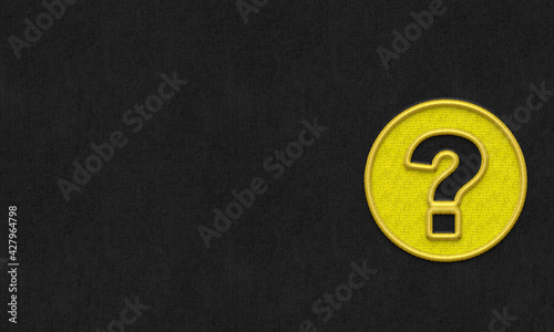 Question mark embroidery on dark background.