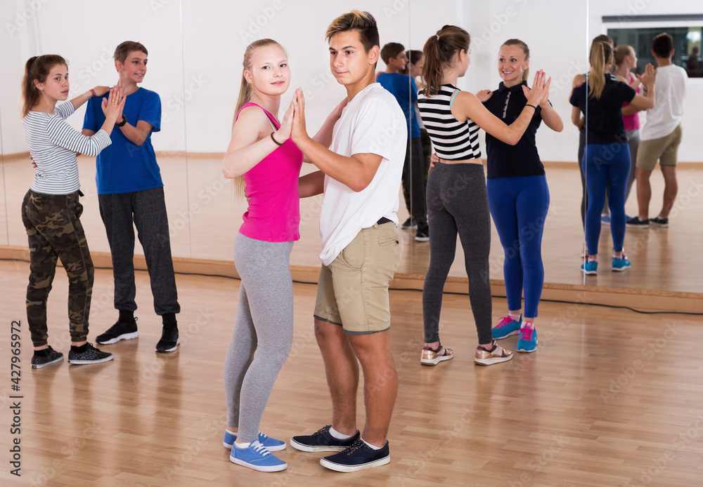 Ordinary teenagers dancing of partner dance at dance school