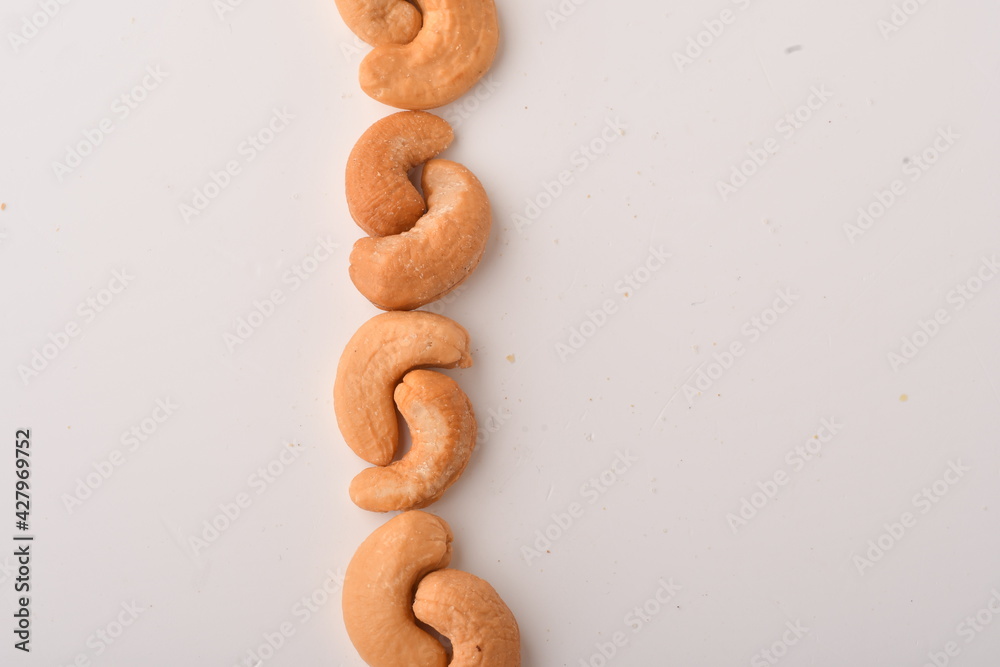 Heap of cashew nuts isolated on white background.
