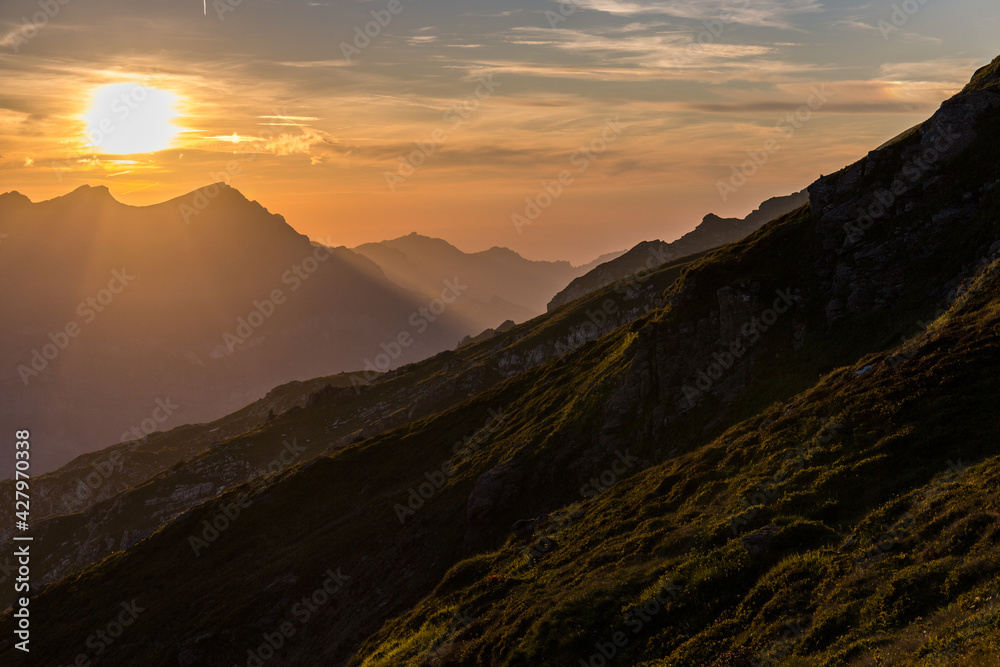 Naklejka premium Sunrise at the daybreak on the mountain area in Fessisseeli, Glarus, Switzerland