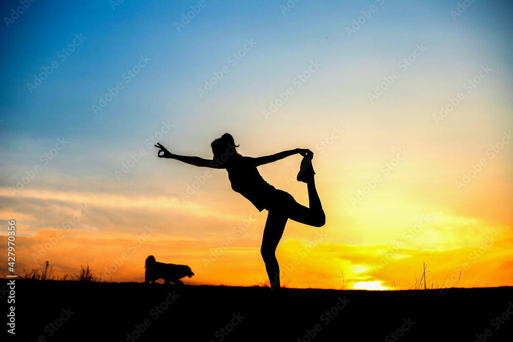 woman in a balancing pose at sunset yoga outdoors woman in a balancing pose at sunset yoga outdoors