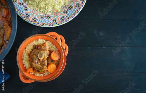 Lamb with couscous on black wooden background. Ramadan and Arabic food.