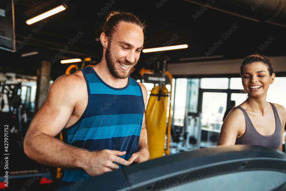Fitness, sport, training, gym concept. Group of smiling people exercising in the gym Fitness, sport, training, gym concept. Group of smiling people exercising in the gym