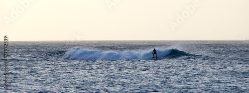 Surfer riding a wave photo