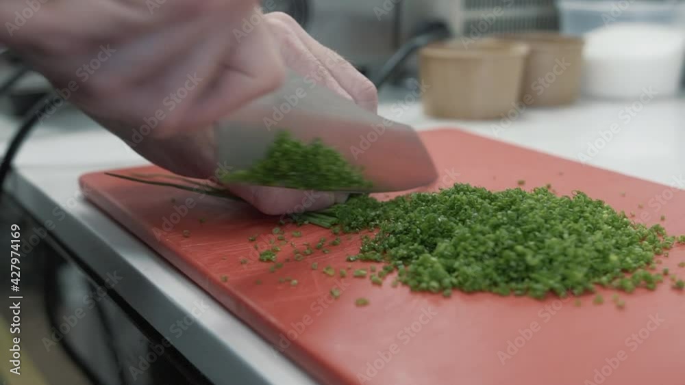Professional skilful chef chopping celery in close up view Professional skilful chef chopping celery in close up view