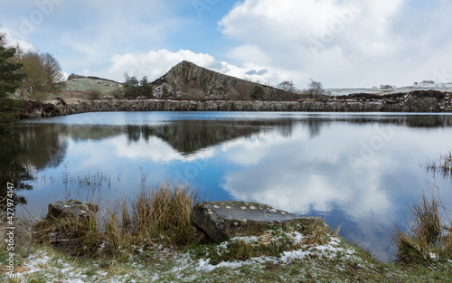 Winter landscape image of Cawfield Quarry and Crag on Hadrian's Wall. Roman Wall, in Northumberland, Engalnd, UK. photo