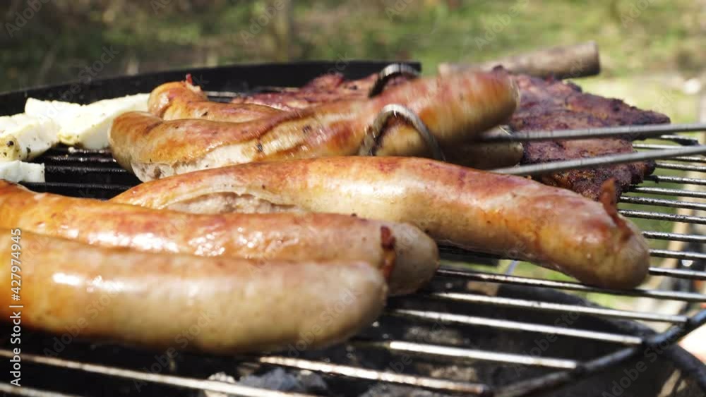 Traditional German Sausages grilled Outside Above Charcoal and Fire Traditional German Sausages grilled Outside Above Charcoal and Fire