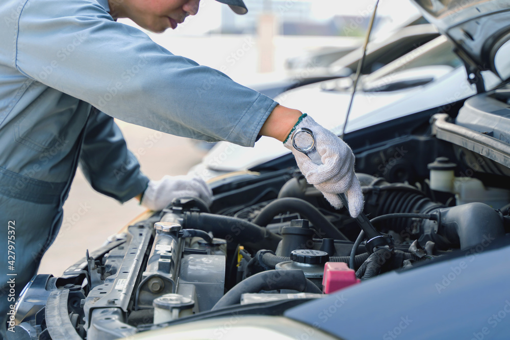 Auto mechanic working in garage. mechanic hand hold wrench. Repair service.