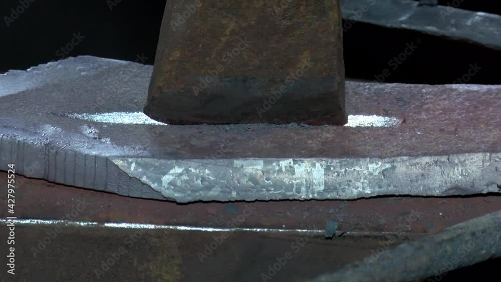Blacksmith works with ferrous hot metal
